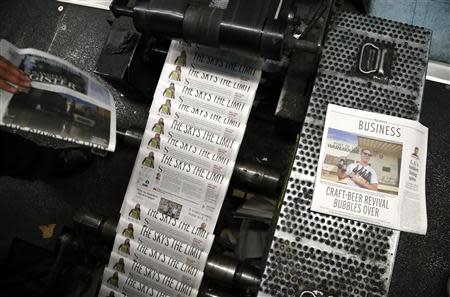 The first copies of the inaugural Los Angeles Register newspaper run off the presses in Santa Ana, California April 16, 2014. REUTERS/Lucy Nicholson (