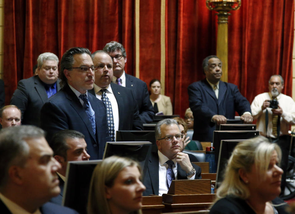 Democrat Nicholas Mattiello, of Cranston, R.I., sits at his seat (lower, middle) in the Rhode Island House of Representatives at the Statehouse in Providence, Tuesday, March 25, 2014 during the voting process for a new House Speaker. Mattiello was elected after the abrupt resignation of Gordon Fox, one of the most powerful figures in state government, after his home and Statehouse office were raided as part of a criminal probe. (AP Photo/Elise Amendola)