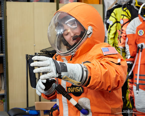 Space.com staff writer Miriam Kramer tries on Final Frontier Design's third generation spacesuit.