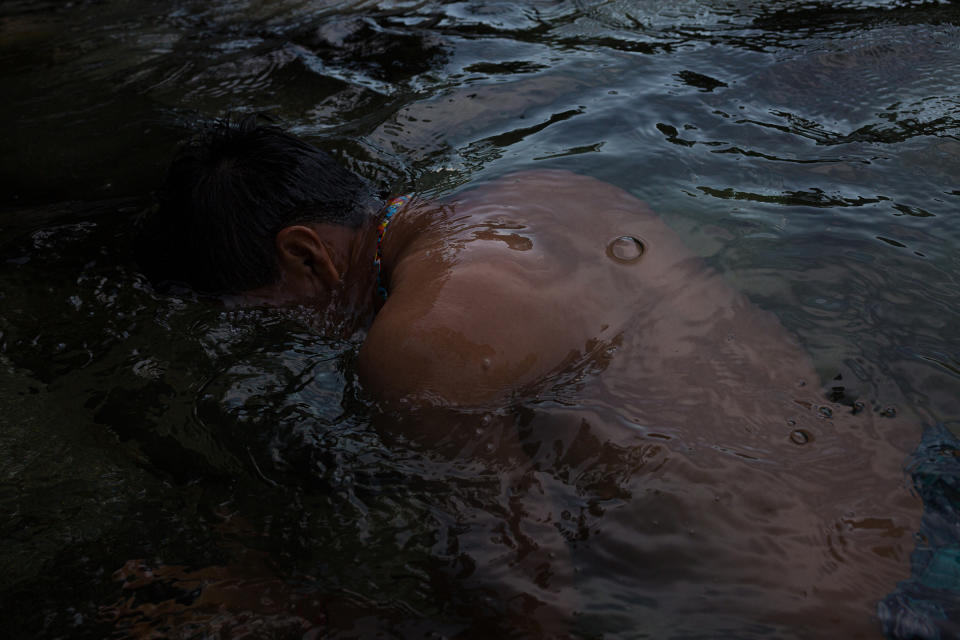 Alexis Grefa, a Kichwa Indigenous activist, takes a dip in the Piatúa River, which he seeks to protect.<span class="copyright">Andrés Yépez for TIME</span>