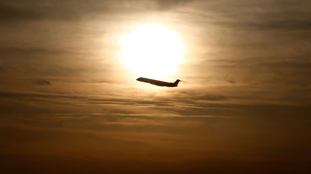 A plane is seen during sunrise at the international airport in Munich