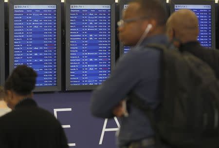 Departure boards show some Delta flights as cancelled flights after Delta Air Lines' computer systems crashed on Monday, grounding flights around the globe, at Hartsfield Jackson Atlanta International Airport in Atlanta, Georgia, U.S. August 8, 2016. REUTERS/Tami Chappell - RTSLUJF