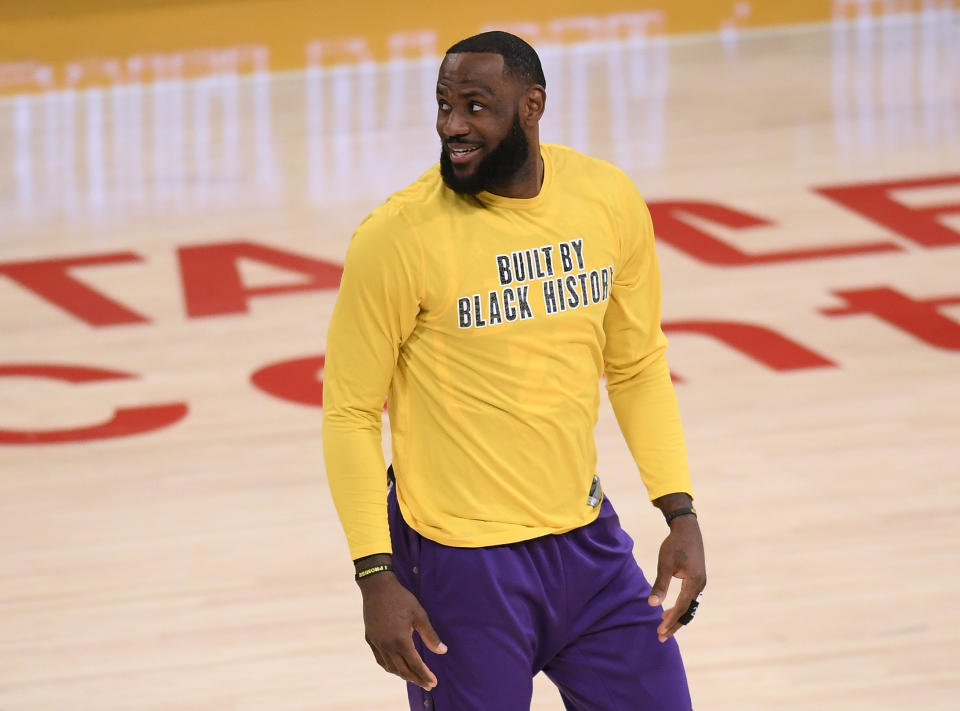 LeBron James in a yellow shirt that reads 