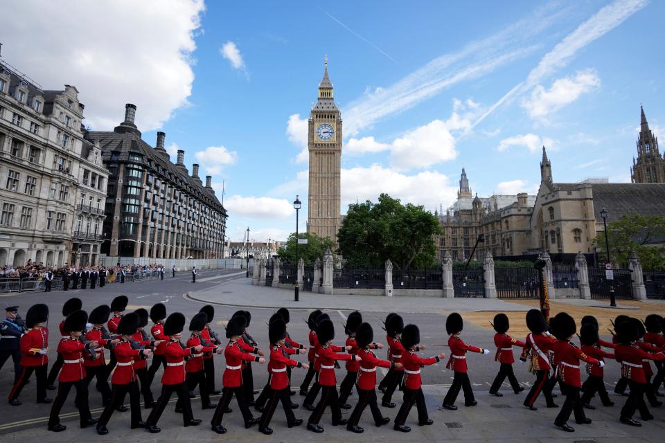 Guards march ahead of the procession of the Gun Carriage which will carry the coffin of Queen Elizabeth II from Buckingham Palace to Westminster Hall in London (via REUTERS)