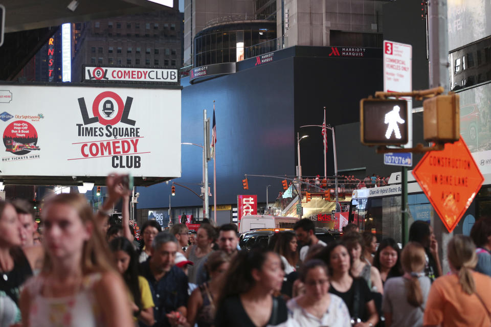 Screens in Times Square are black during a widespread power outage, Saturday, July 13, 2019, in the Manhattan borough of New York. Authorities say a transformer fire caused a power outage in Manhattan and left businesses without electricity, elevators stuck and subway cars stalled. (AP Photo/Michael Owens)