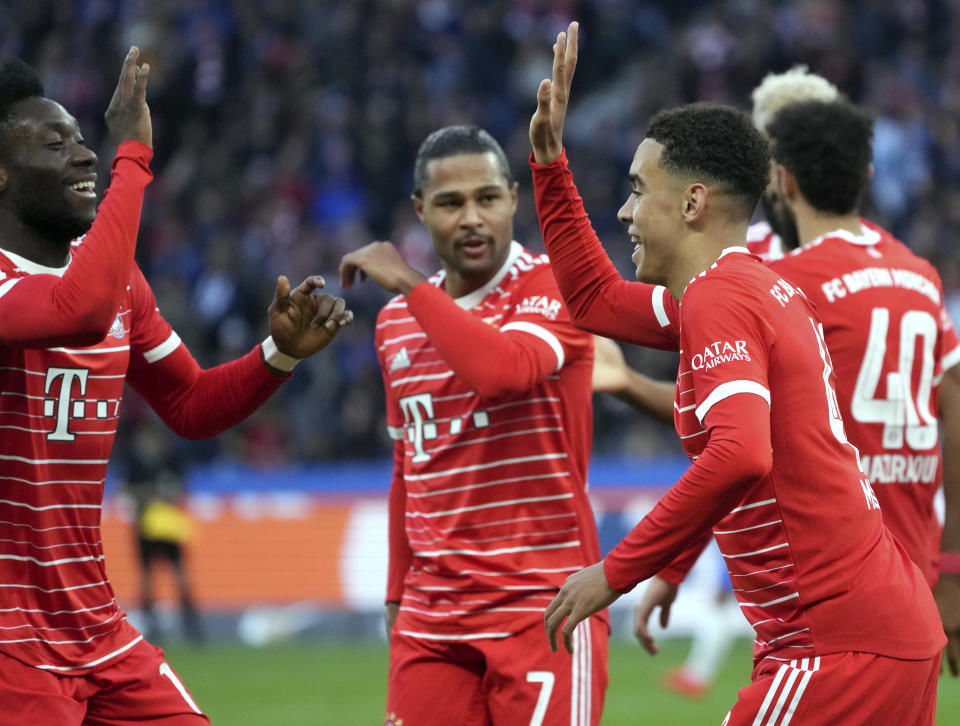 Bayern's Jamal Musiala, right, celebrates after scoring the opening goal during the German Bundesliga soccer match between Hertha BSC Berlin and FC Bayern Munich in Berlin, Germany, Saturday, Nov. 5, 2022. (AP Photo/Michael Sohn)