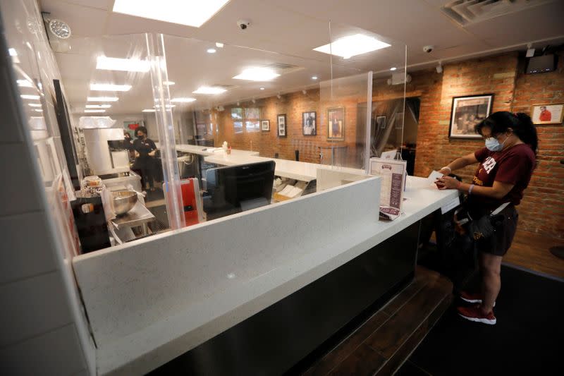 Customer orders from takeout menu inside Sylvia's Restaurant in Harlem in New York