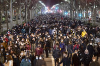 Supporters of rap singer Pablo Hasel march along an avenue during a demonstrations condemning his arrest in Barcelona, Spain, Tuesday, Feb. 16, 2021. The imprisonment of Pablo Hasel for inciting terrorism and refusing to pay a fine after having insulted the country's monarch has triggered a social debate and street protests. (AP Photo/Emilio Morenatti)