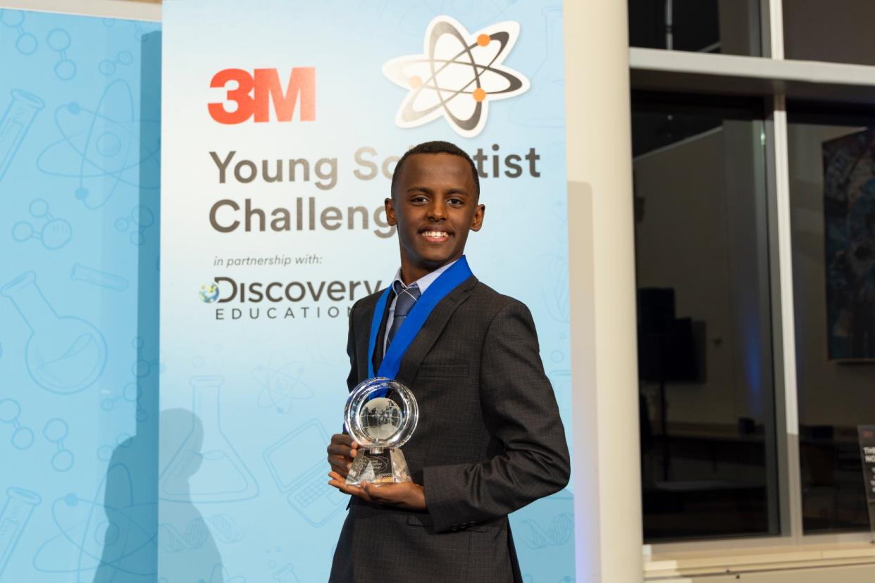  Heman Bekele holds his trophy for winning the 3M Young Scientist Challenge. 