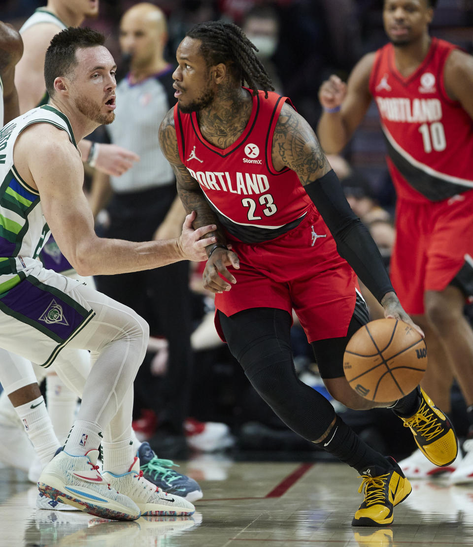 Portland Trail Blazers guard Ben McLemore, right, dribbles around Milwaukee Bucks guard Pat Connaughton during the first half of an NBA basketball game in Portland, Ore., Saturday, Feb. 5, 2022. (AP Photo/Craig Mitchelldyer)