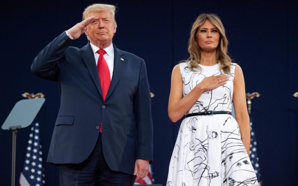 US President Donald Trump and First Lady Melania Trump during the national anthem - SAUL LOEB/AFP