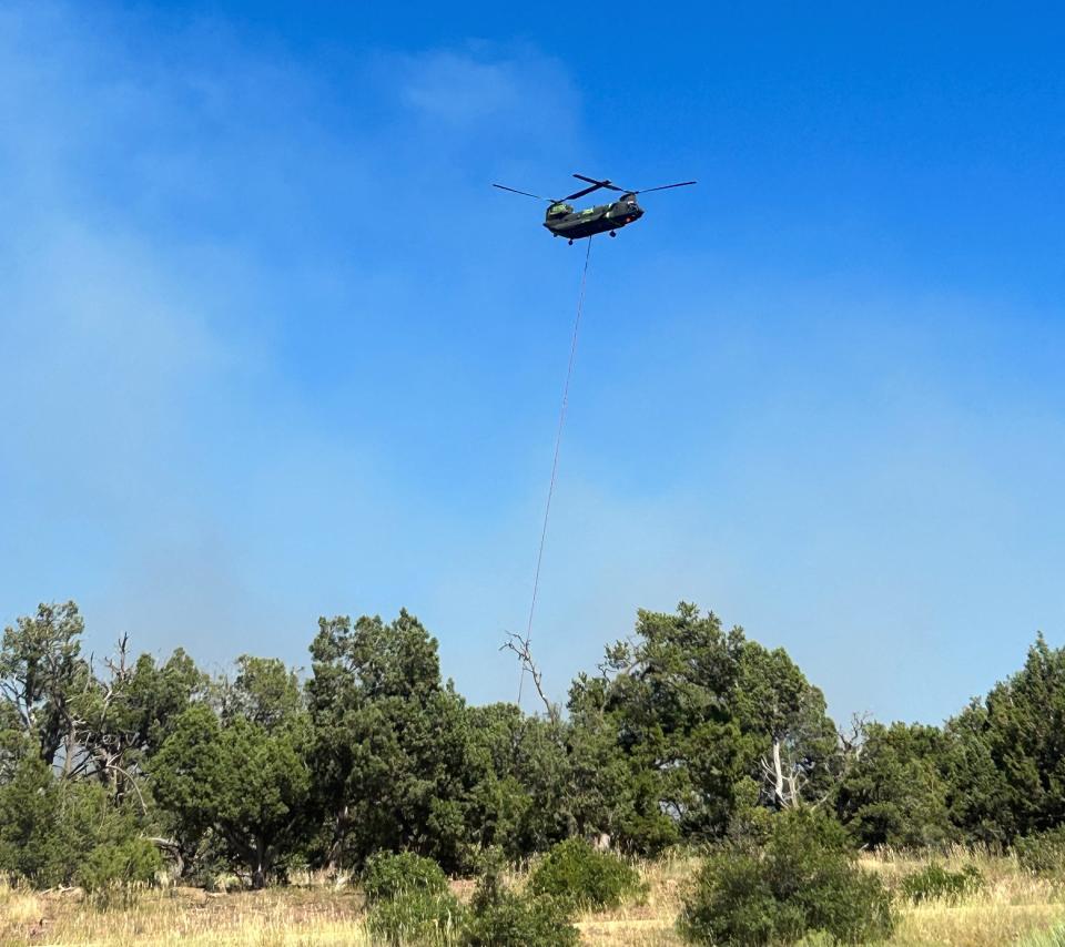 A helicopter crew engineers a water drop on the American Mesa Fire on the Carson National Forest.