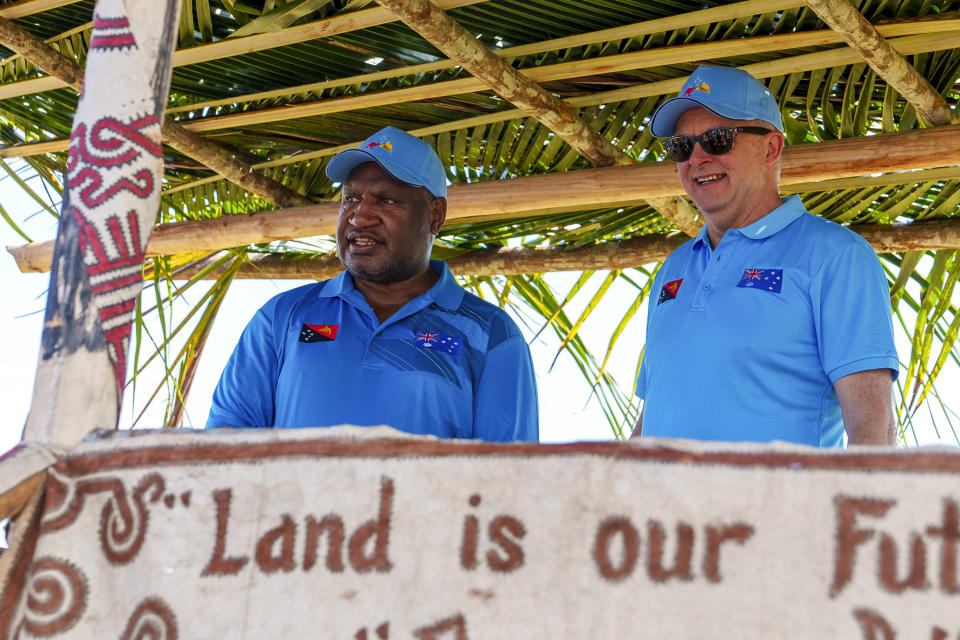 In this image supplied by the Australian Prime Ministers office, Australian Prime Minister Anthony Albanese, right, and Papua New Guinea Prime Minister James Marape watch as local villagers performa traditional welcome before they start their walk along the Kokoda Track at Kokoda Village, Papua New Guinea, Tuesday, April 23, 2024. The prime ministers on Tuesday began trekking into the South Pacific island nation’s mountainous interior to commemorate a pivotal World War II campaign and to underscore their current security alliance that is challenged by China's growing regional influence. (Prime Ministers office via AP)