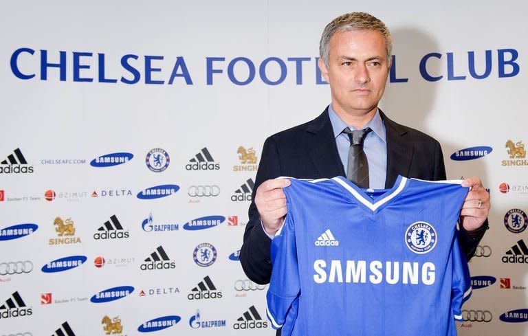 Chelsea football club's new manager Jose Mourinho poses for pictures as he addresses a press conference at Stamford Bridge in London, on June 10, 2013