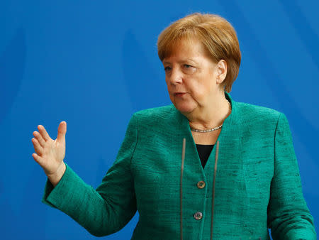 German Chancellor Angela Merkel addresses a news conference after talks with Italian Prime Minister Paolo Gentiloni in Berlin, Germany, February 16, 2018. REUTERS/Hannibal Hanschke