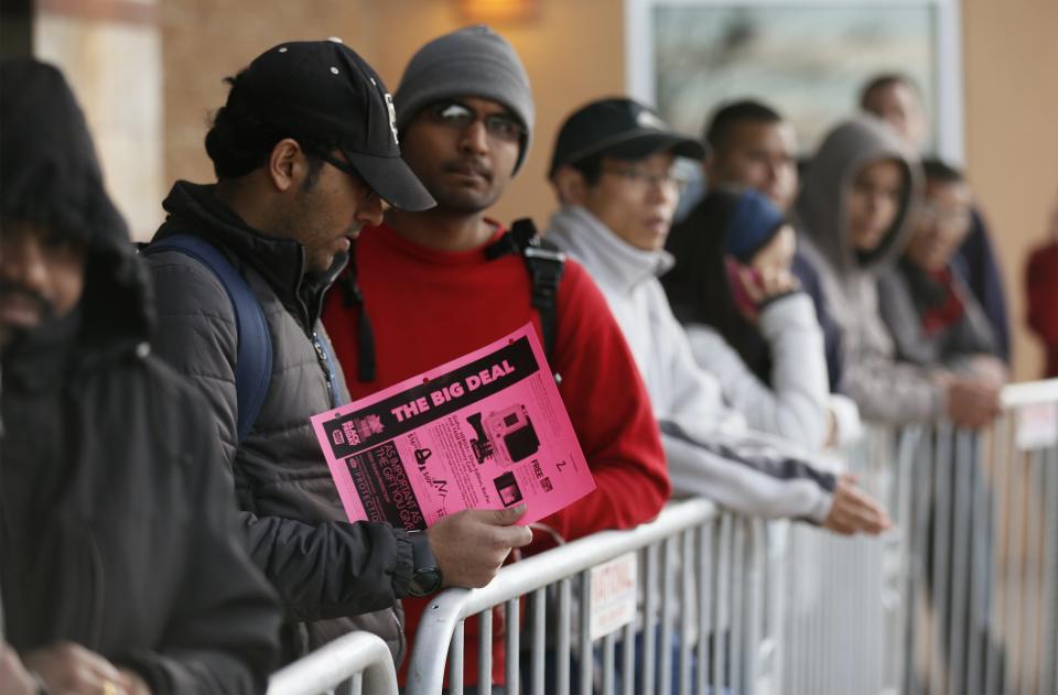 Shoppers wait for a Best Buy store to open on Thanksgiving Day to get pre-Black Friday bargains using tickets issued to them in line outside the store in Broomfield