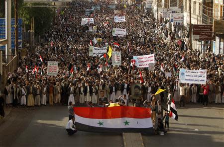 Protesters loyal to the Shi'ite Muslim Al-Houthi group, also known as Ansarullah, march during a demonstration against potential strikes on the Syrian government, in Sanaa August 30, 2013. REUTERS/Khaled Abdullah