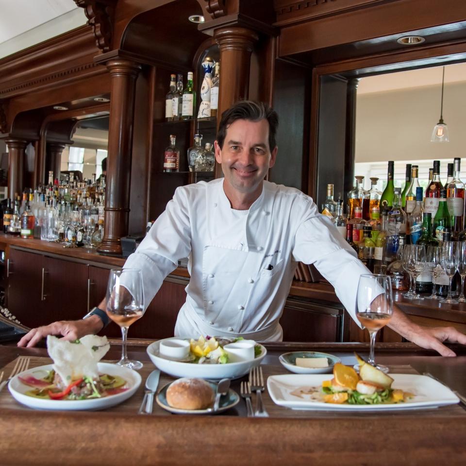 Chef James Laird smiles behind the bar at his restaurant Serenade in Chatham.