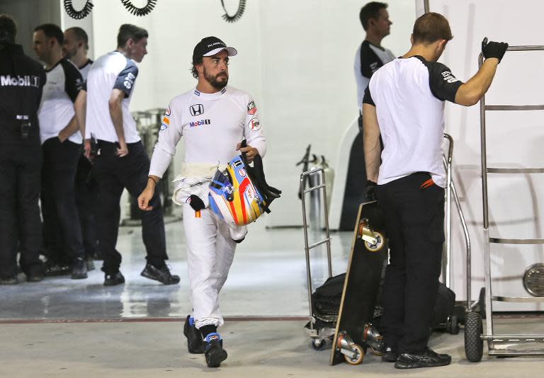 McLaren driver Fernando Alonso walks down the pit during the qualification session for the Bahrain Grand Prix on April 18, 2015