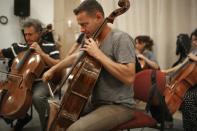 The Israel Camerata Jerusalem Orchestra play instruments from the "Violins of Hope" project during a rehearsal