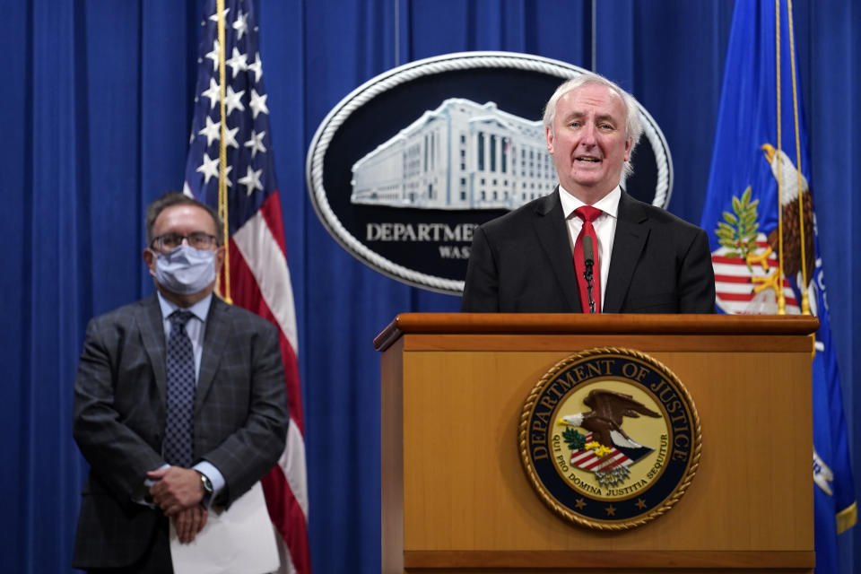 Deputy Attorney General Jeffrey Rosen, right, and Environmental Protection Agency (EPA) Administrator Andrew Wheeler, left, speaks during a news conference at the Justice Department in Washington, Monday, Sept. 14, 2020. Automakers Daimler AG and subsidiary Mercedes-Benz USA have agreed to pay $1.5 billion to the U.S. government and California state regulators to resolve emissions cheating allegations. (AP Photo/Susan Walsh, Pool)