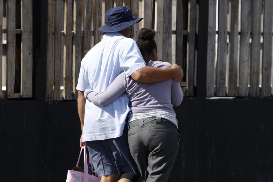 Navy Yard workers evacuated after the shooting are reunited with loved ones at a makeshift Red Cross shelter at the Nationals Park baseball stadium near the affected naval installation in Washington, September 16, 2013. (REUTERS/Jonathan Ernst)