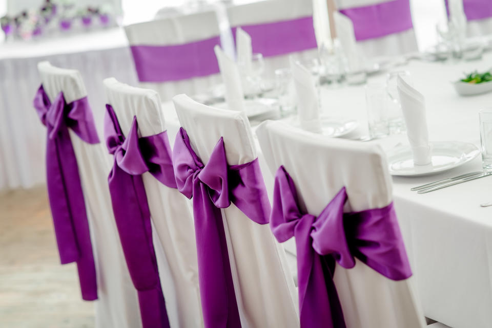 Wedding chair cover with a bow ribbon around it