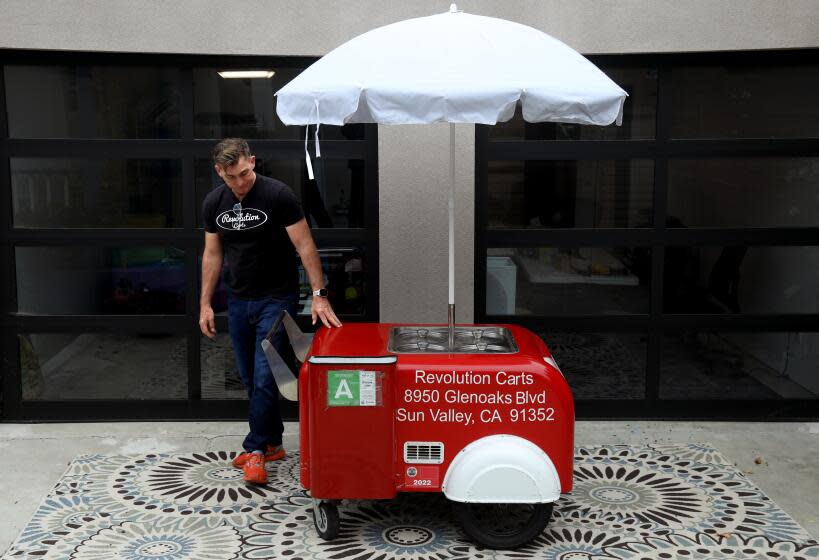 CULVER CITY, CA - MAY 28, 2024 - Matt Geller, a co-founder of Revolution Carts, stands next to the first permitted Tamalero food cart the company made. Geller was photographed at his home in Culver City on May 28, 2024. The company has made 87 Tamalero food carts to date. A $6 million LA County effort to build and distribute 200 food carts to local vendors for free is lagging - and vendors are suffering, according to Geller. While the county has been working with a nonprofit called Inclusive Action (since 2022) to build and distribute the 200 carts, Revolution has released a code-complaint cart of its own: the Tamalero, which can be used for tamales, breakfast burritos, hot dogs and more. Geller says the County's lack of expertise on the matter is delaying the project. But county officials contend that their program, which is funded by federal COVID-19 stimulus money, is doing far more than just building carts. They say that the educational components of their program are key to its success - and must come before any carts are distributed. (Genaro Molina/Los Angeles Times)