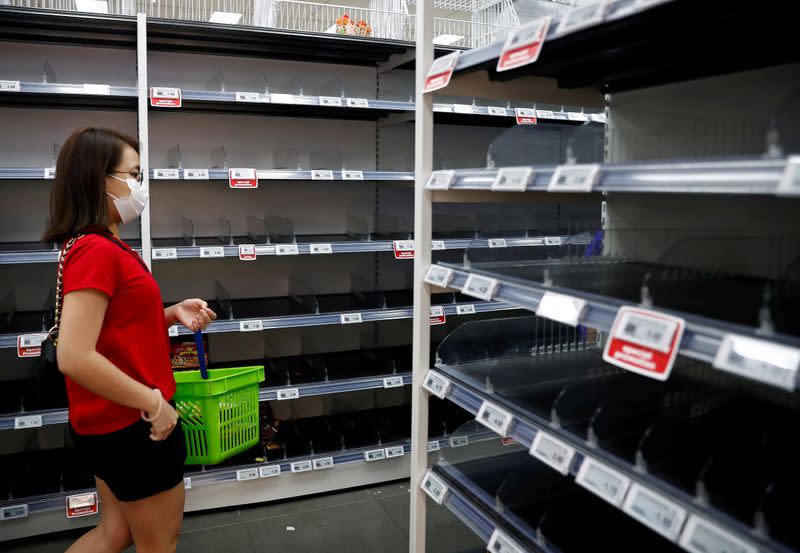 FILE PHOTO: People stock up on food supplies after Singapore raised coronavirus outbreak alert level to orange