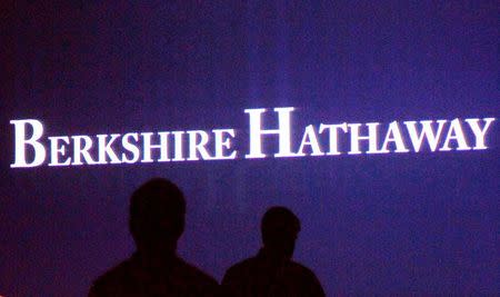 Berkshire Hathaway shareholders walk by a video screen at the company's annual meeting in Omaha May 4, 2013. REUTERS/Rick Wilking/Files