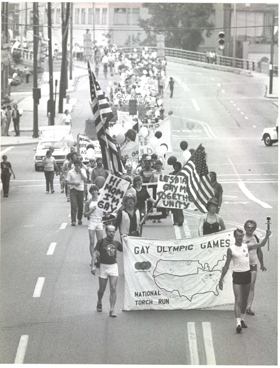 1982 - Black and white file photo. The marchers head southbound on Front Street in Columbus  to the west of the Nationwide building.  June 26, 1982.  About 1,000 people marched through Downtown in Columbus’ first Gay Pride Parade on June 26, 1982. *** Parade - Gay Pride March - Columbus *** Used June 27, 1982. *** More background:  In June 1981, 200 people marched from Ohio State University to the Ohio Statehouse to commemorate the Stonewall Inn riot of 1969, which was a key event in the fight for gay rights. The following year, Columbus held its first Gay Pride Parade, organized by Stonewall Columbus, with about 1,000 marchers. Some resources say the Pride Parade started with the 1981 march and some say it started in 1982, since that was the first year it was officially named the Gay Pride Parade.