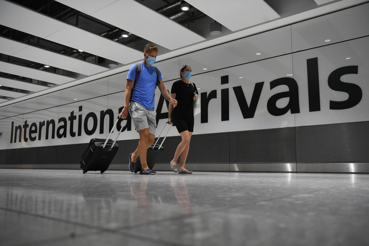 Passengers wearing face masks as they arrive at Heathrow Airport after a flight from Dubrovnik, Croatia, landed. The UK government announced that from 4am on Saturday, travellers to the UK from Croatia, Austria and Trinidad and Tobago will have to quarantine for 14 days on arrival.