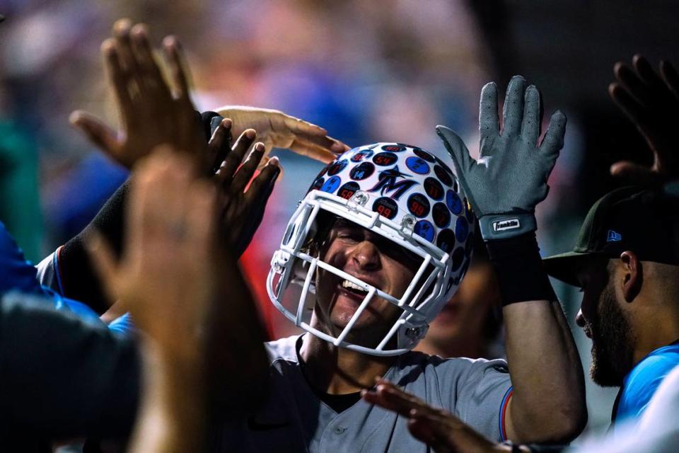 Miami Marlins’ JJ Bleday is congratulated for a home run off Philadelphia Phillies’ Zack Wheeler during the fourth inning of a baseball game Tuesday, Aug. 9, 2022, in Philadelphia.