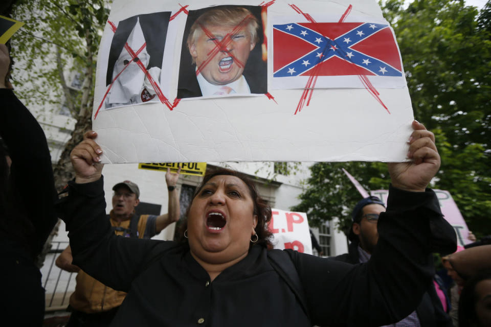 Protester Ingrid Vaca demonstrates outside Republican National Committee (RNC) headquarters, where Republican U.S. presidential candidate Donald Trump was meeting with House Speaker Paul Ryan and RNC Chairman Reince Priebus in Washington, U.S., May 12, 2016. (Jim Bourg/Reuters)