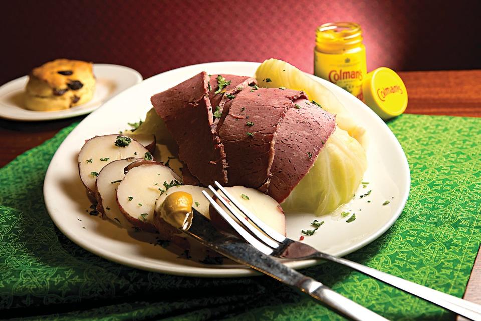 Slices of corned beef, served over a bed of cabbage and side of boiled potatoes.