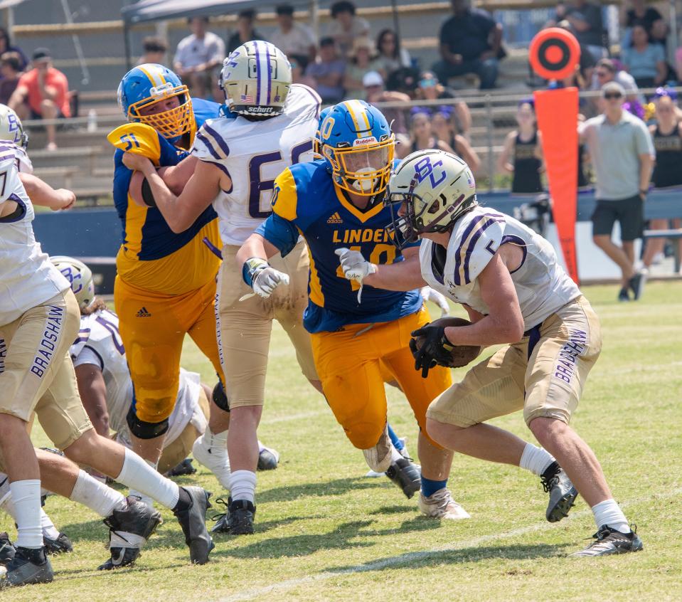 20210828.    Linden High's Tony Cowan catches Bradshaw Christian's Dylan Forbeck in the backfield for a loss on Saturday August 28, 2021.