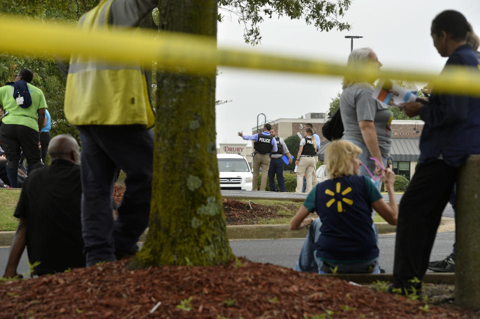 Officers and employees gather in a nearby parking lot after a shooting at a Walmart store Tuesday, July 30, 2019 in Southaven, Miss. (Photo: Brandon Dill/AP)