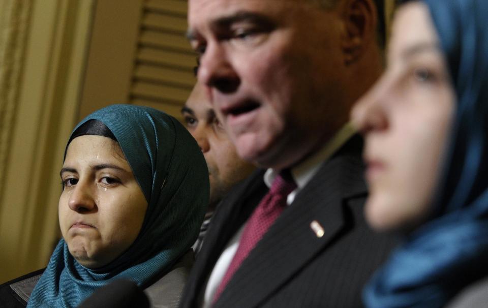 Sen. Tim Kaine, D-Va., chairman of the Senate Foreign Relations subcommittee on Near Eastern, Southern and Central Asian Affairs, second from right, speaks as Heba Sawan, left, tears up during a news conference with sister Amineh Sawan, right, and Anas al-Dabas, second from left, on Capitol Hill in Washington, Thursday, Feb. 6, 2014. The Sawan sisters were survivors of the August 2013 chemical weapons attack in Moadamiya, Syria that left more than 1,200 Syrians dead and many more wounded. Al-Dabas witnessed the 2012 massacre in Daraya that took the lives of 540 Syrians. (AP Photo/Susan Walsh)