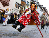 <p>A young Federahannes, a jester figure from Rottweil, is participating in the Narrensprung (jester jump) parade in Rottweil, southern Germany, Monday, Feb. 27, 2016. About 4000 jesters paraded through the city among thousands of spectators. (AP Photo/Michael Probst) </p>