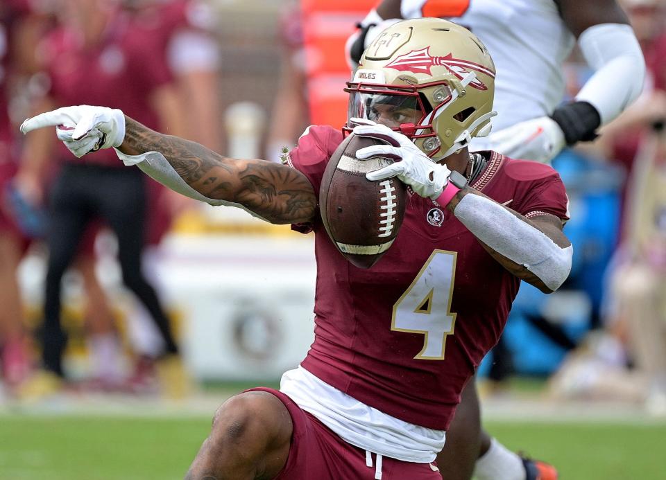 Oct 14, 2023; Tallahassee, Florida, USA; Florida State Seminoles wide receiver Keon Coleman (4) celebrates after catching a pass over Syracuse Orange defensive back Jason Simmons Jr. (6) (not pictured) during the first quarter at Doak S. Campbell Stadium. Mandatory Credit: Melina Myers-USA TODAY Sports