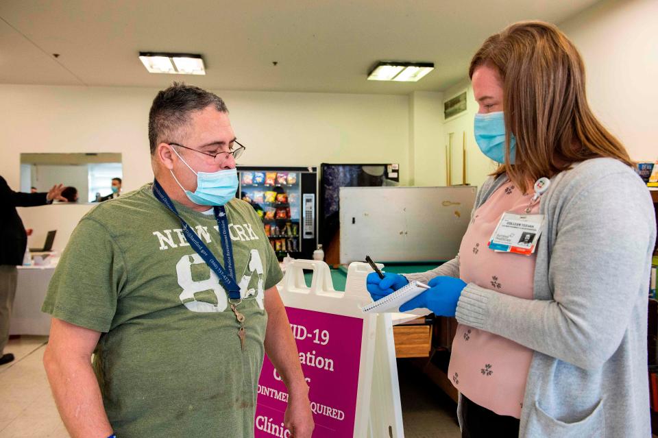 William Torres, 56, a resident of The Open Hearth mens shelter, prepares to receive the Pfizer-BioNTech Covid-19 vaccine from a Mobile Vaccination Clinic run by Hartford HealthCare in Hartford, Connecticut, on Jan. 22, 2021.