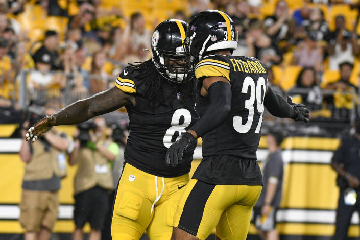 Pittsburgh Steelers defensive end Melvin Ingram (8) celebrates with free safety Minkah Fitzpatrick (39) after tackling Detroit Lions running back Dedrick Mills for a loss in the first half of an NFL preseason football game, Saturday, Aug. 21, 2021, in Pittsburgh. (AP Photo/Don Wright)