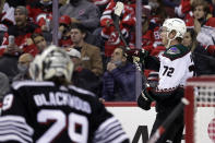 Arizona Coyotes center Travis Boyd (72) reacts after scoring a goal past New Jersey Devils goaltender Mackenzie Blackwood during the second period of an NHL hockey game Wednesday, Jan. 19, 2022, in Newark, N.J. (AP Photo/Adam Hunger)