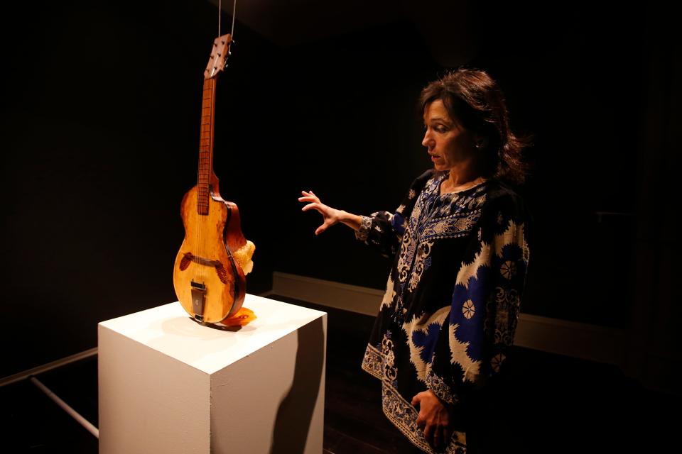 New Bedford Art Museum director Suzanne de Vegh speaks about the guitar with a beehive attached. This piece is entitled 309Hz by Rachel Rosenkrantz and is part of the Gateways to Awareness show currently on display at the New Bedford Art Museum.