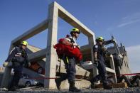 Rescue specialists for USA-1 leave the scene of a mock disaster area during a training exercise at the Guardian Center in Perry, Georgia, March 24, 2014. (REUTERS/Shannon Stapleton)