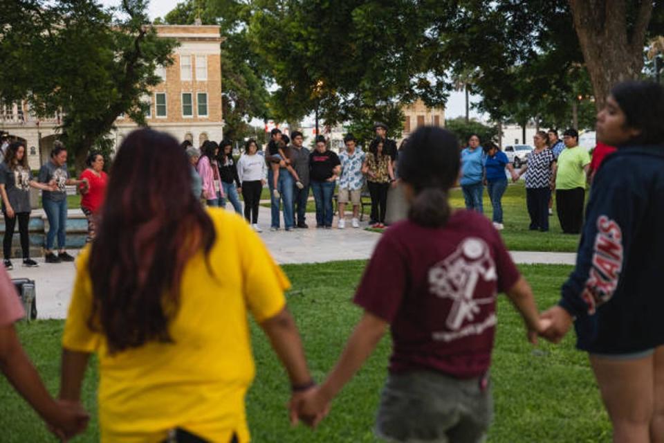 Uvalde residents gather for a vigil following the mass shooting at a school (Jordan Vonderhaar / Getty Images)