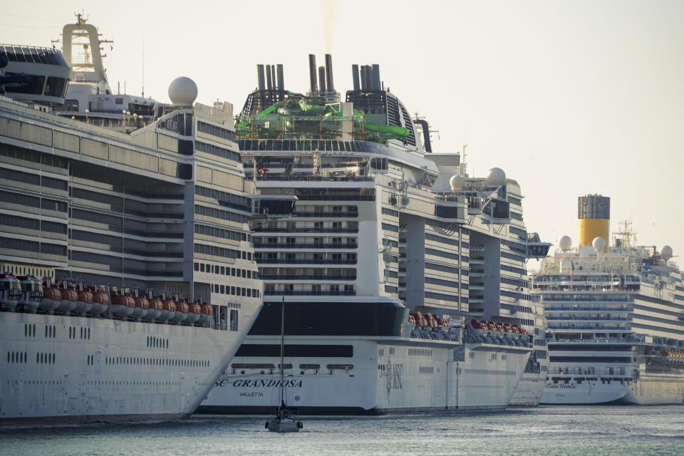 A view of the MSC Grandiosa cruise ship, center, in Civitavecchia, near Rome, Wednesday, March 31, 2021. MSC Grandiosa, the world's only cruise ship to be operating at the moment, left from Genoa on March 30 and stopped in Civitavecchia near Rome to pick up more passengers and then sail toward Naples, Cagliari, and Malta to be back in Genoa on April 6. For most of the winter, the MSC Grandiosa has been a lonely flag-bearer of the global cruise industry stalled by the pandemic, plying the Mediterranean Sea with seven-night cruises along Italy’s western coast, its major islands and a stop in Malta. (AP Photo/Andrew Medichini)