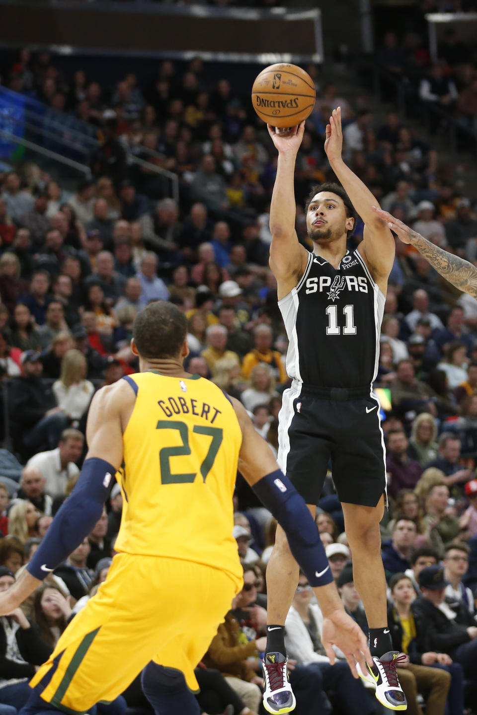 San Antonio Spurs guard Bryn Forbes (11) shoots as Utah Jazz center Rudy Gobert (27) defends during the first half of an NBA basketball game Friday, Feb. 21, 2020, in Salt Lake City. (AP Photo/Rick Bowmer)