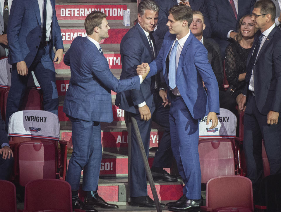 Juraj Slafkovsky, right, is congratulated by Shane Wright after being selected as the first overall pick by the Montreal Canadiens during the NHL hockey draft in Montreal on Thursday, July 7, 2022. (Graham Hughes/The Canadian Press via AP)