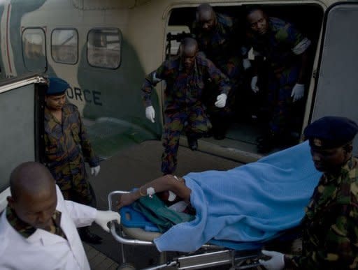 A policeman wounded in one of the attacks on churches in the Kenyan town of Garissa, near the border with Somalia, is off-loaded from an air-ambulance by paramedics. Gunmen killed 17 people and wounded dozens in gun and grenade attacks on two churches Sunday in the Kenyan town of Garissa near the border with Somalia, officials said